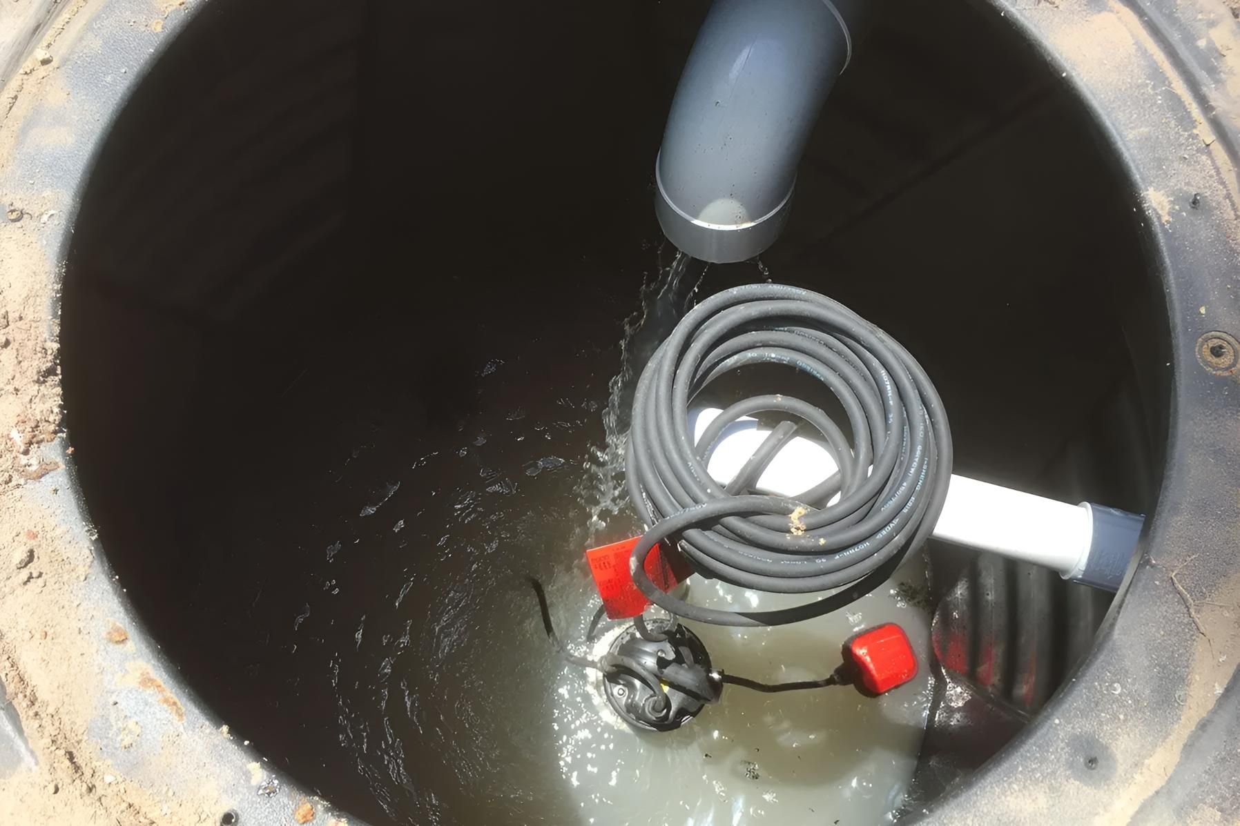 A Manhole Cover With a Hose Coming Out of It — Shawline Plumbing and Drainage In Maclean, NSW