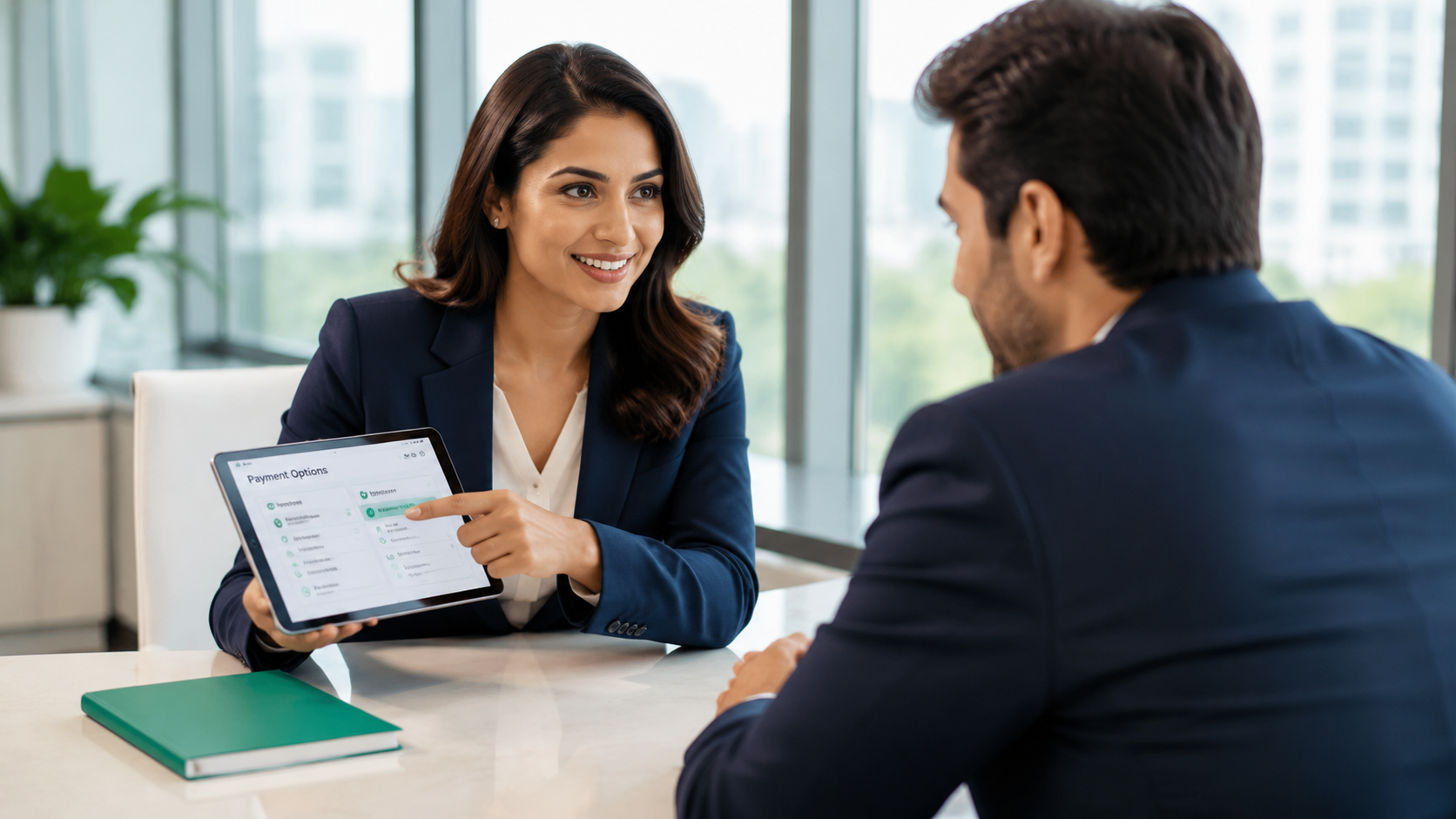 Business meeting in an office, woman showing a tablet to a man across the table.