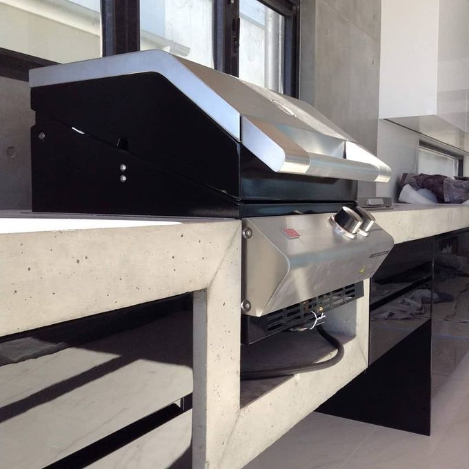 A Stainless Steel Grill Is Sitting On Top Of A Concrete Counter — Simonetto'S Cabinets & Joinery in Nambour, QLD