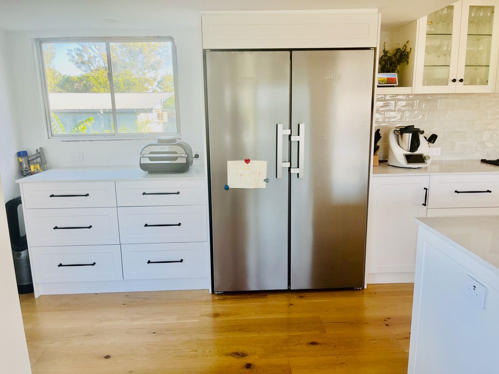 White custom kitchen cabinets with stainless steel fridge – Simonetto's Cabinets & Joinery
