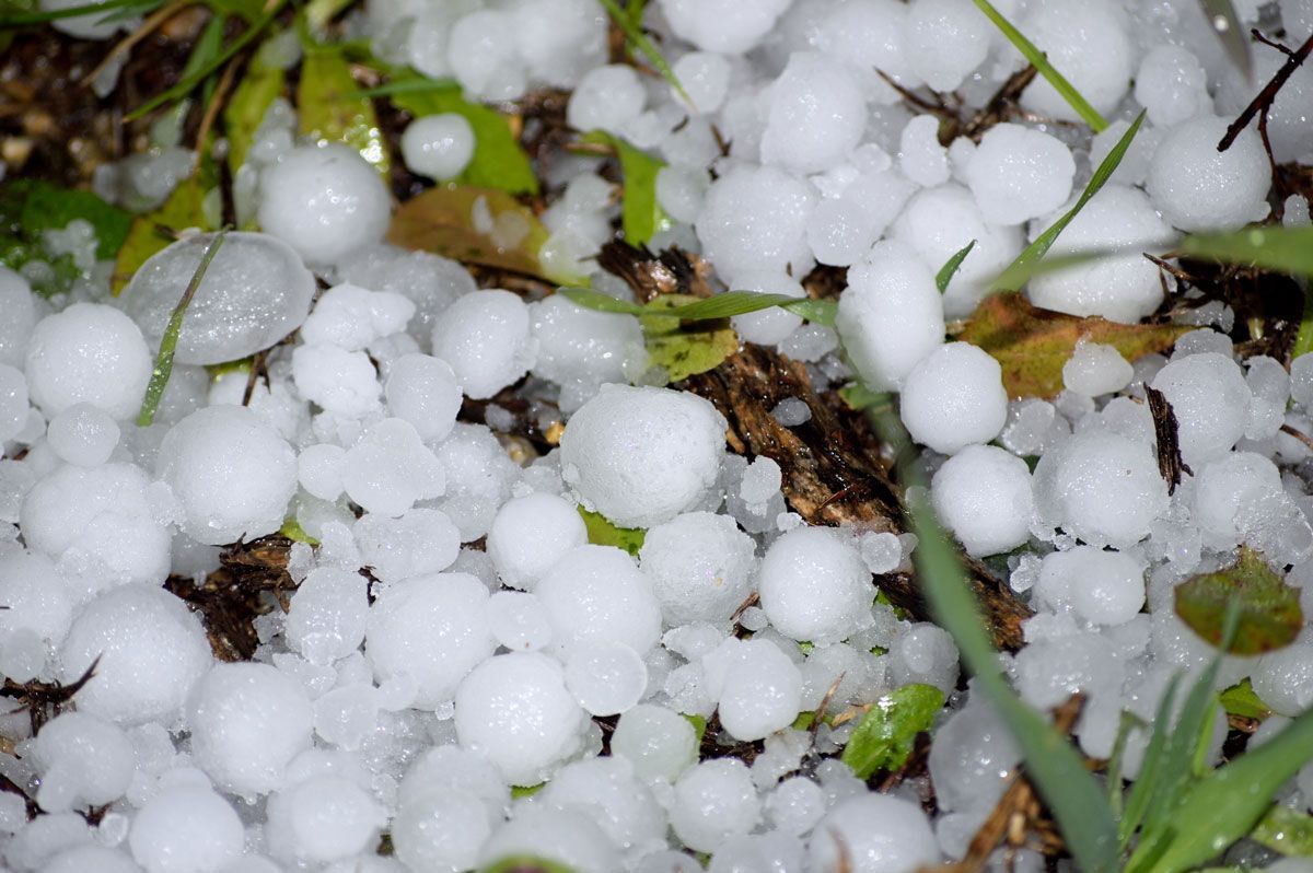 A close up of a pile of hail on the ground — Holmen, WI — Riverland Exteriors Corporation