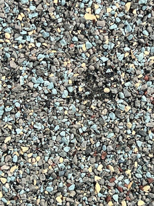 A close up of a pile of gravel with blue and yellow stones.