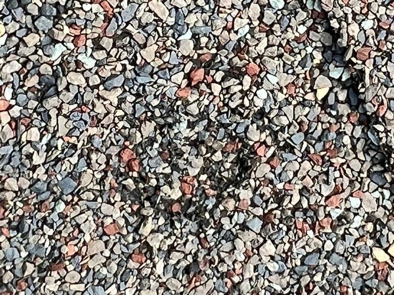 A pile of gravel is sitting on the ground.