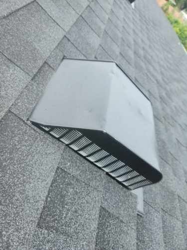 A black box is sitting on top of a roof.