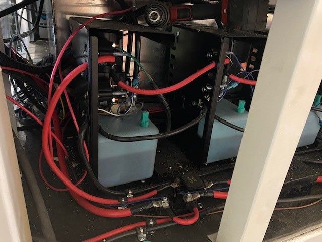 Red hoses and a gray battery pack inside a mobile slaughter trailer in Idaho Falls ID