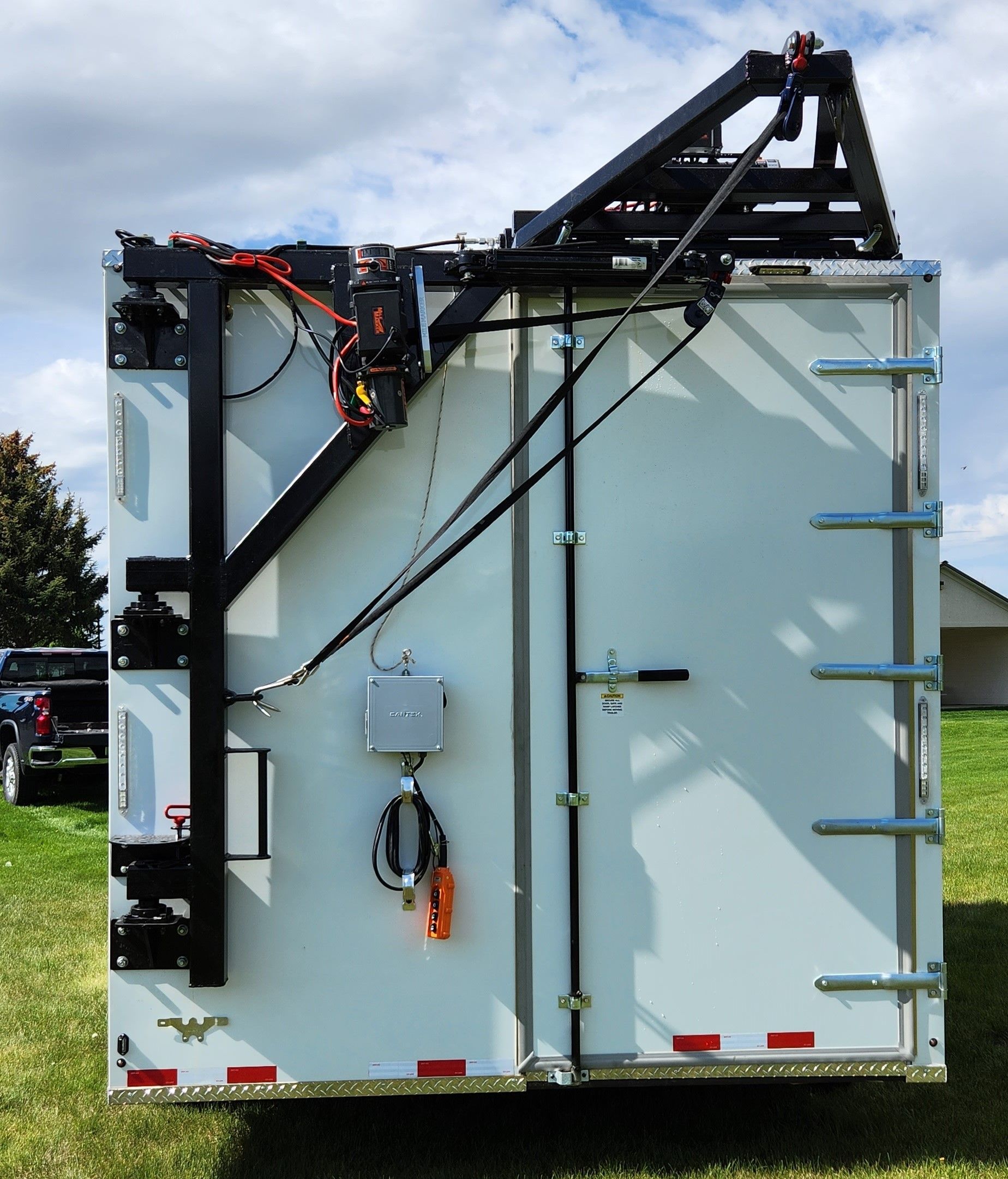 Rear view of Sentinel trailer with black crane arm and side-mounted equipment.