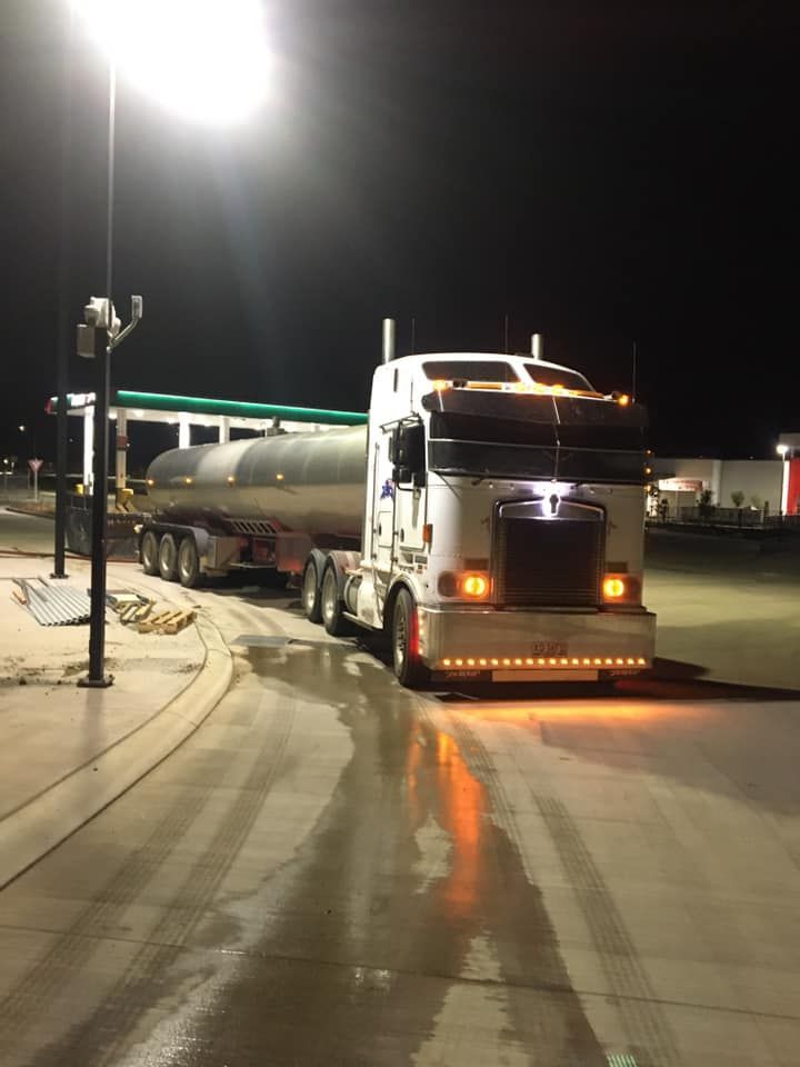 A Semi Truck Is Parked in A Parking Lot at Night — Stolzenberg Water Carriers in Gympie, QLD