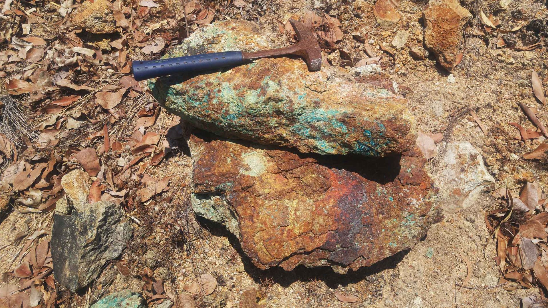 A Hammer Is Sitting On Top Of A Rock In The Dirt – Port Pirie, SA - Flinders Earthmoving & Blue Metal Supplies