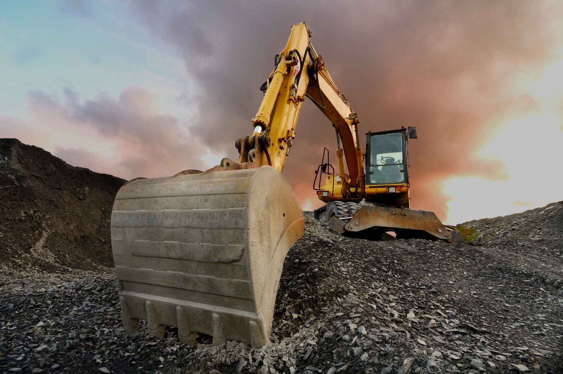 A Yellow Excavator Is Working On A Construction Site – Port Pirie, SA - Flinders Earthmoving & Blue Metal Supplies