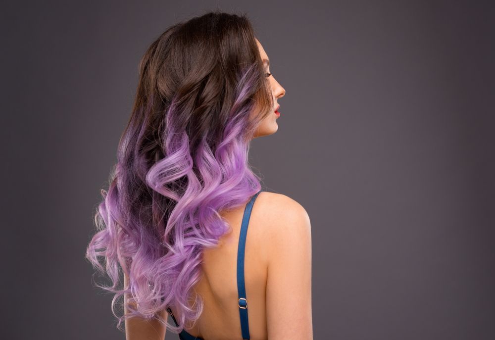 Woman with brown to purple balayage wavy hair — Southside Hair & Beauty Design In South Tamworth, NSW