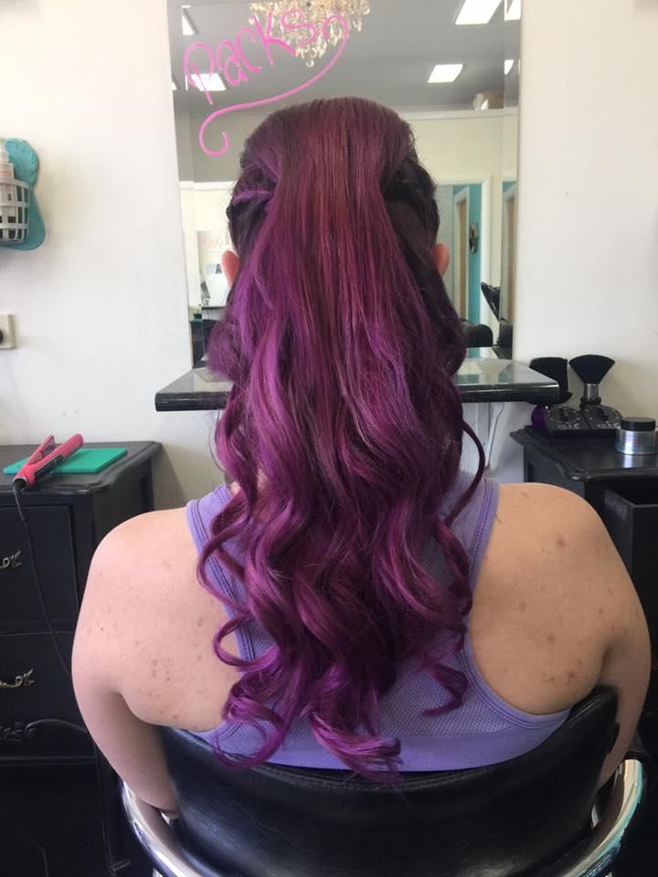 A Woman With Purple Hair is Sitting in a Chair in Front of a Mirror — Southside Hair & Beauty Design In South Tamworth, NSW