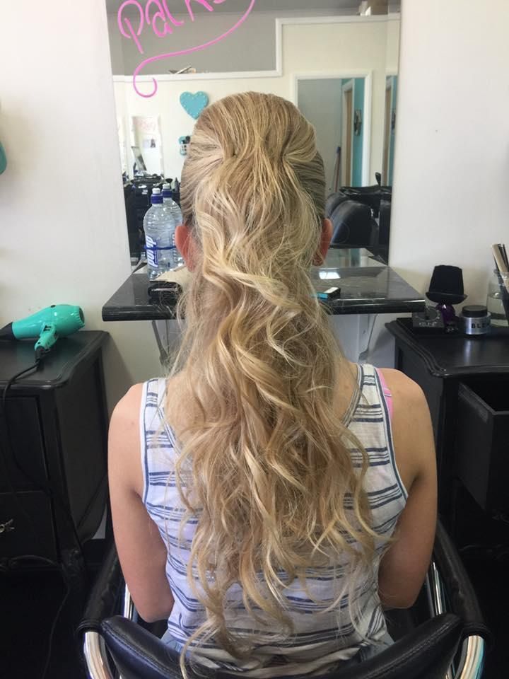 A Woman is Sitting in a Chair With Her Hair in a Ponytail — Southside Hair & Beauty Design In South Tamworth, NSW