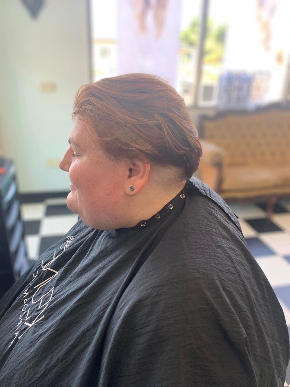 A Woman is Getting Her Hair Cut at a Barber Shop — Southside Hair & Beauty Design In South Tamworth, NSW