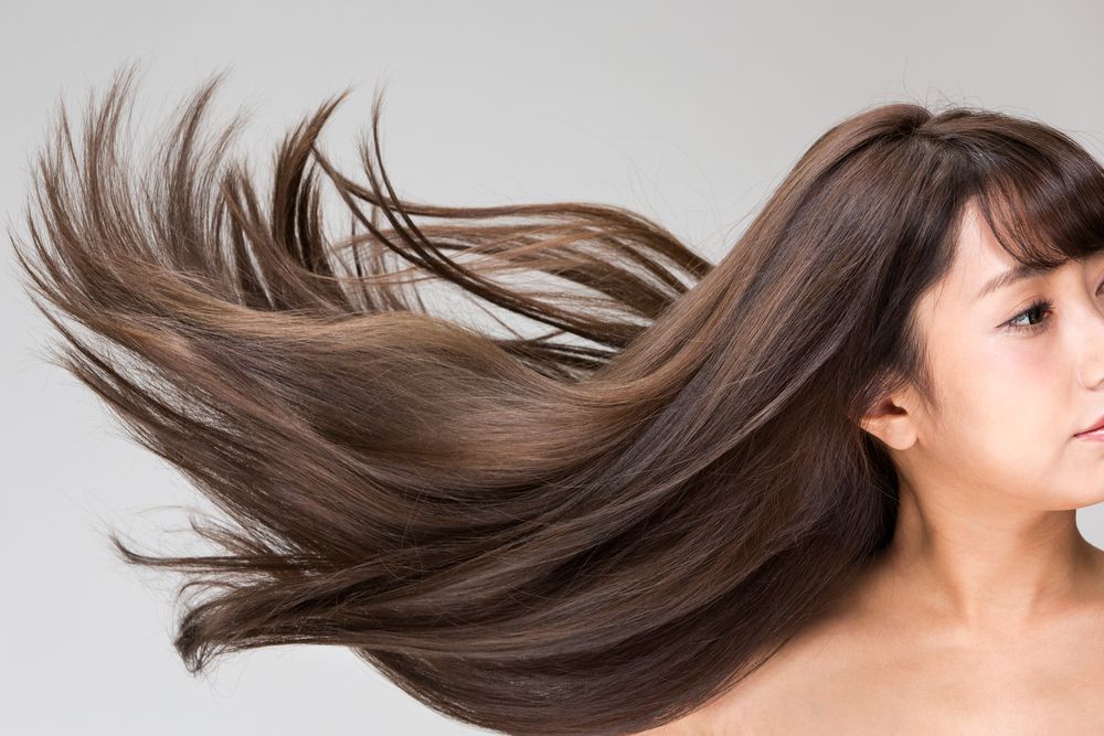 Woman With Brown Hair Blowing in the Wind — Southside Hair & Beauty Design In South Tamworth, NSW