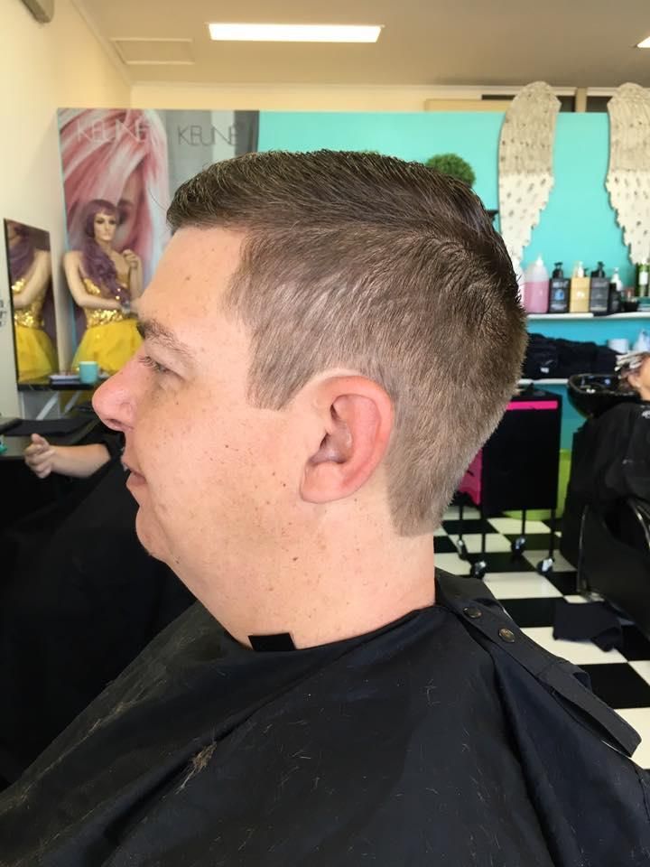 A Man is Getting His Hair Cut in a Salon — Southside Hair & Beauty Design In South Tamworth, NSW
