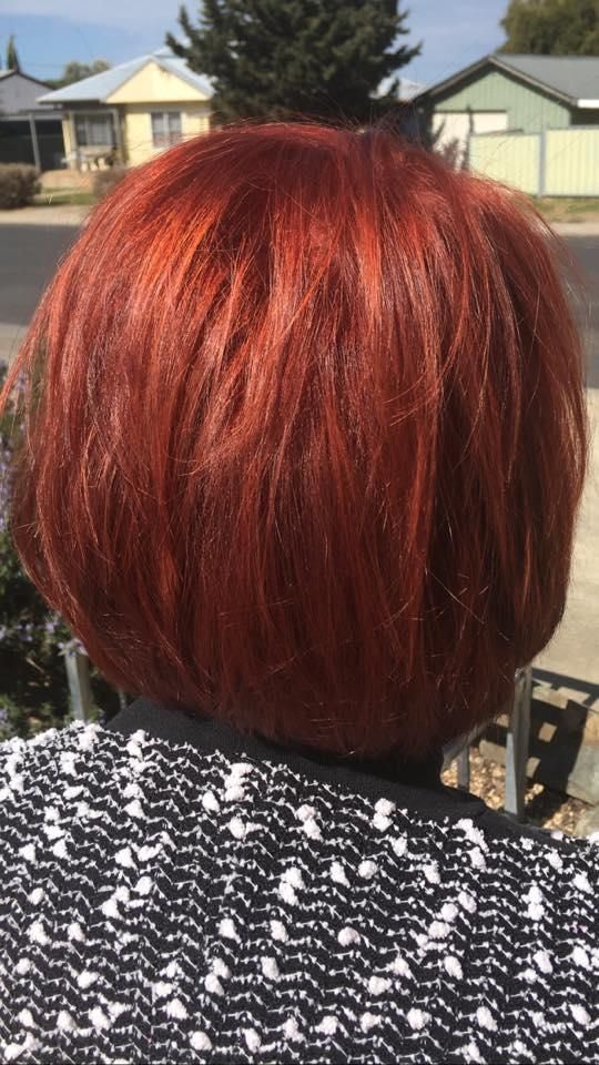 A Woman With Red Hair is Wearing a Black and White Sweater — Southside Hair & Beauty Design In South Tamworth, NSW