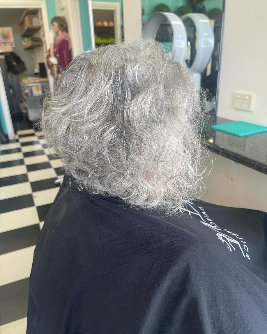 A Woman With Gray Hair is Sitting in a Chair in a Hair Salon — Southside Hair & Beauty Design In South Tamworth, NSW