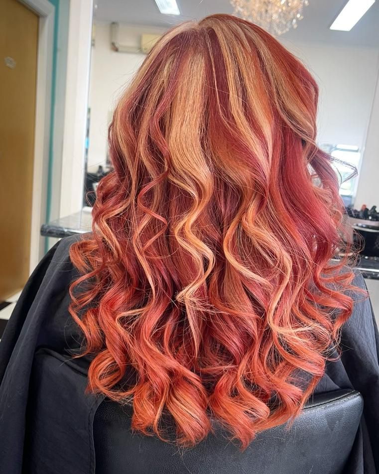 A Woman With Red Hair is Sitting in a Chair in a Salon — Southside Hair & Beauty Design In South Tamworth, NSW