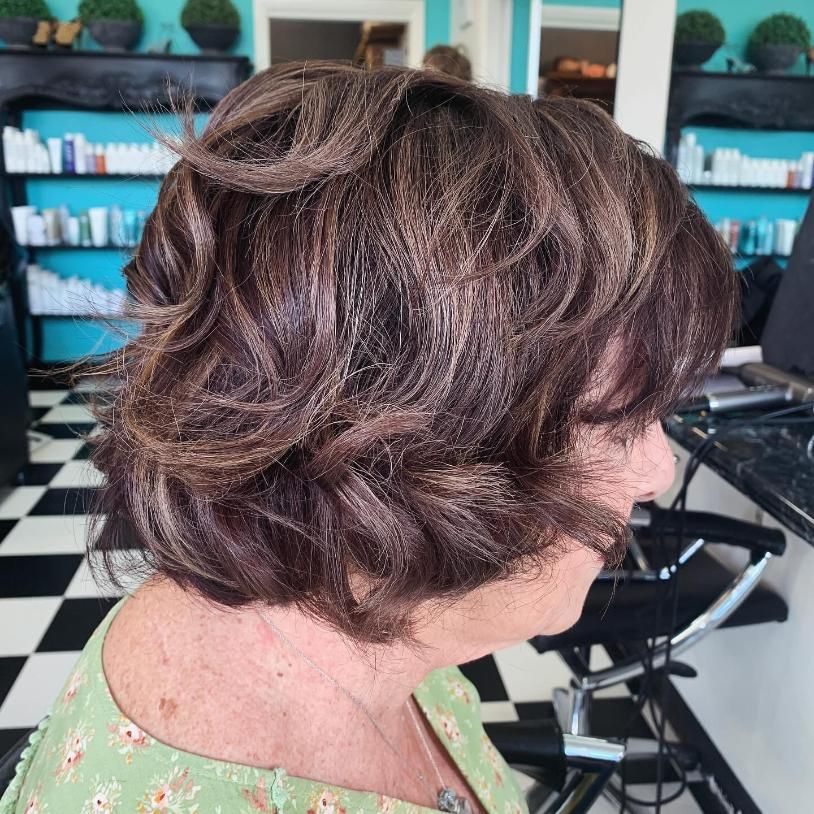 A Woman With Short Brown Hair is Sitting in a Chair in a Salon — Southside Hair & Beauty Design In South Tamworth, NSW