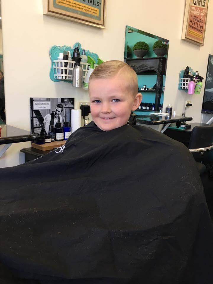 A Young Boy is Getting His Hair Cut at a Barber Shop — Southside Hair & Beauty Design In South Tamworth, NSW
