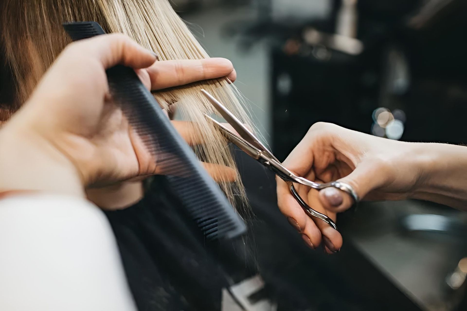 A Woman Getting Hair Cut by a Hairdresser — Southside Hair & Beauty Design In South Tamworth, NSW