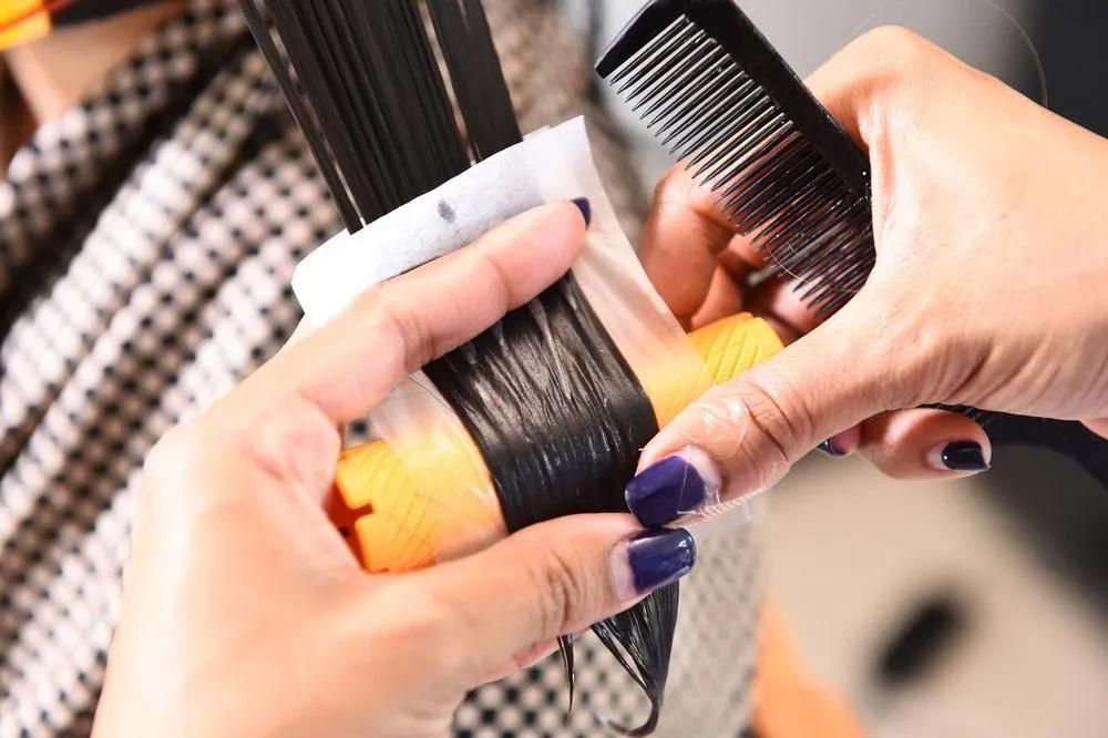 A Woman With Purple Nails is Getting Her Hair Cut by a Hairdresser — Southside Hair & Beauty Design In South Tamworth, NSW A Woman With Purple Nails is Getting Her Hair Cut by a Hairdresser — Southside Hair & Beauty Design In South Tamworth, NSW