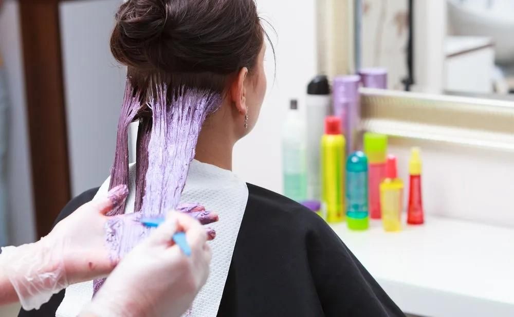 A Woman is Getting Her Hair Dyed in a Salon — Southside Hair & Beauty Design In South Tamworth, NSW A Woman is Getting Her Hair Dyed in a Salon — Southside Hair & Beauty Design In South Tamworth, NSW