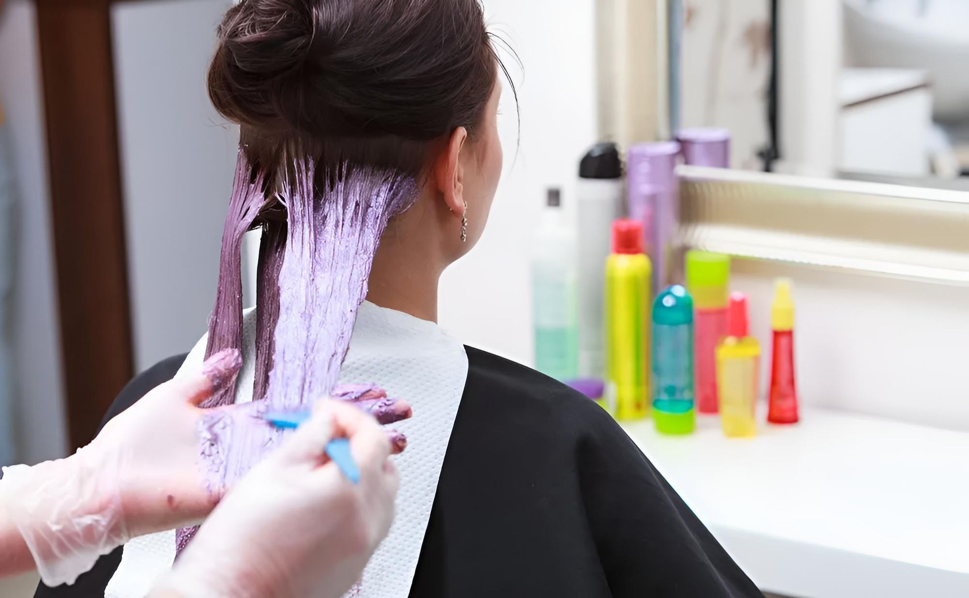 A Woman is Getting Her Hair Dyed in a Salon — Southside Hair & Beauty Design In South Tamworth, NSW