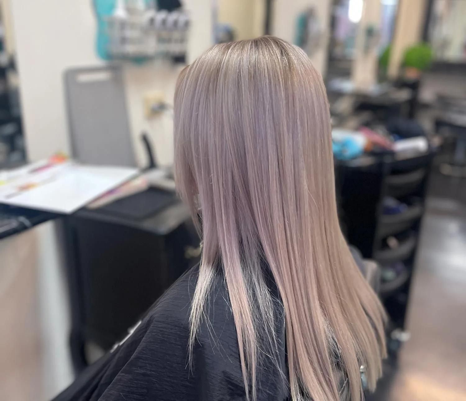 A Woman With Long Blonde Hair is Sitting in a Chair in a Salon — Southside Hair & Beauty Design In South Tamworth, NSW A Woman With Long Blonde Hair is Sitting in a Chair in a Salon — Southside Hair & Beauty Design In South Tamworth, NSW