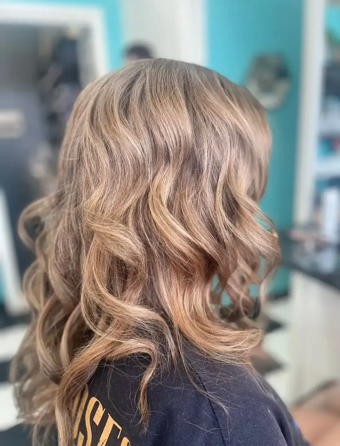 A Woman With Short Purple Hair is Sitting in a Chair at a Hair Salon — Southside Hair & Beauty Design In South Tamworth, NSW