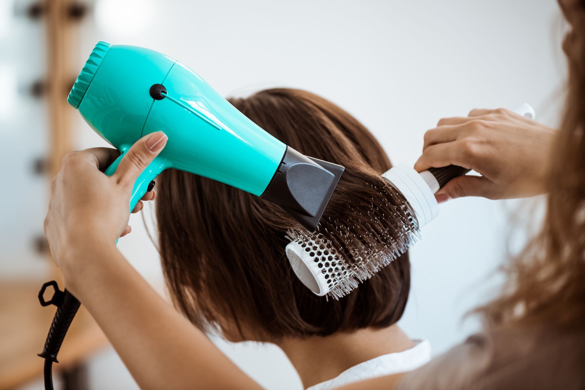 Woman Smiling as Hair is Blow-dried by Unseen Hand — Southside Hair & Beauty Design In South Tamworth, NSW