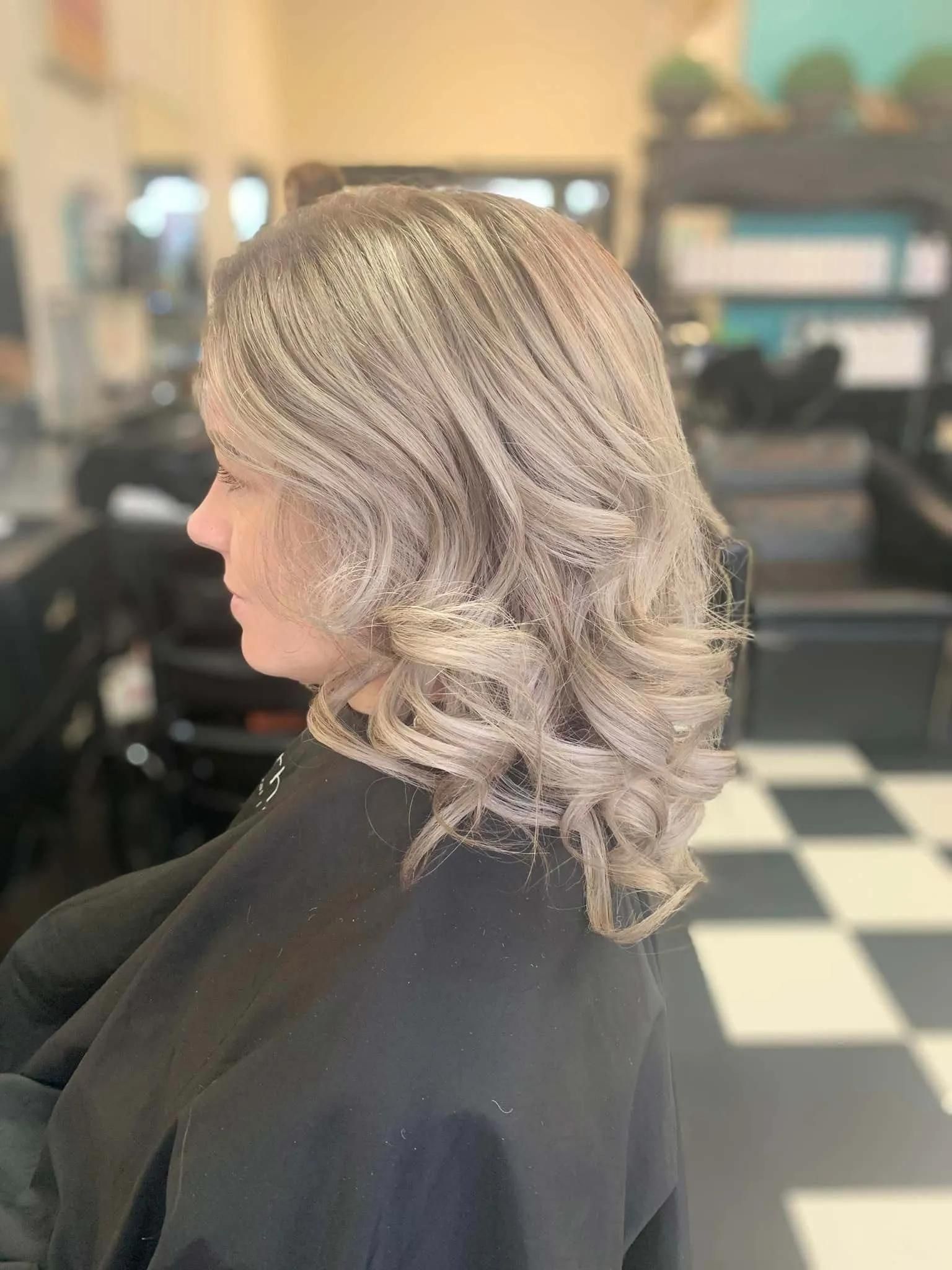 A Woman is Getting Her Hair Cut in a Salon — Southside Hair & Beauty Design In South Tamworth, NSW