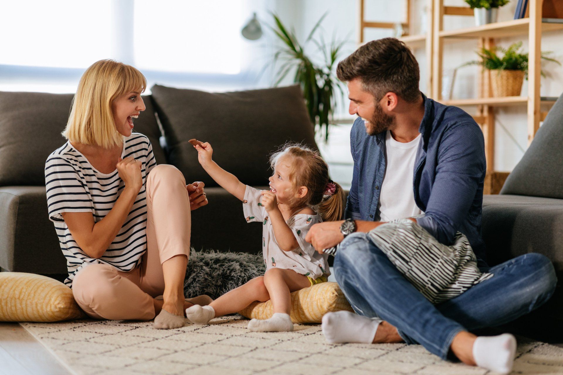 couple and daughter playing