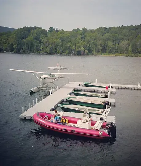 a boat is docked at a dock on a lake .