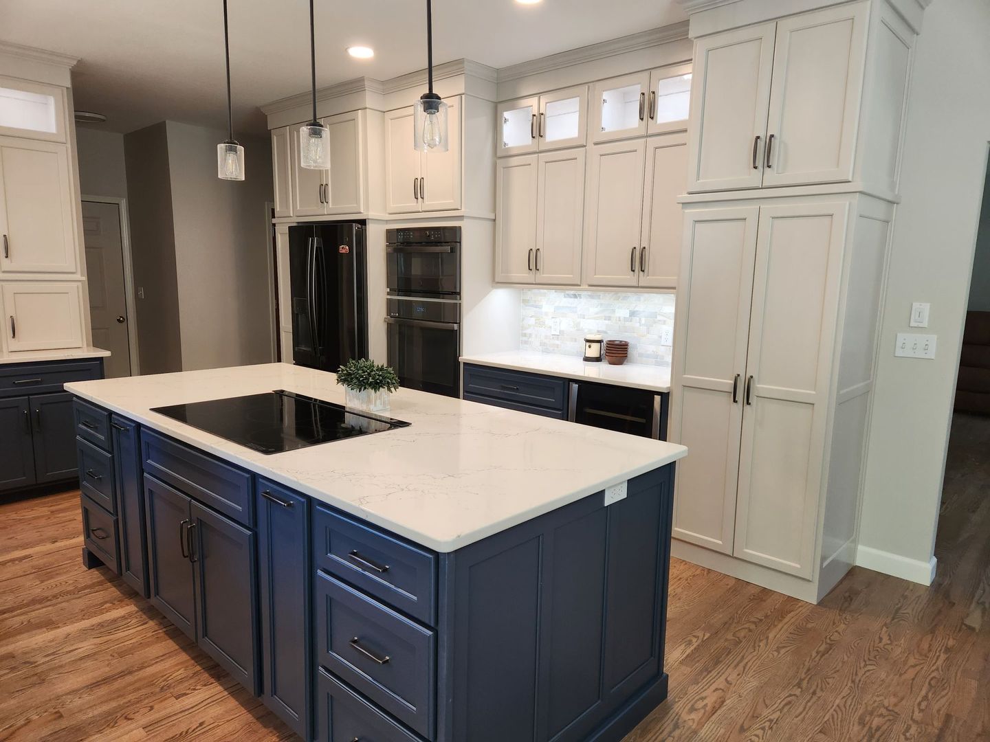 A kitchen with blue cabinets and white counter tops