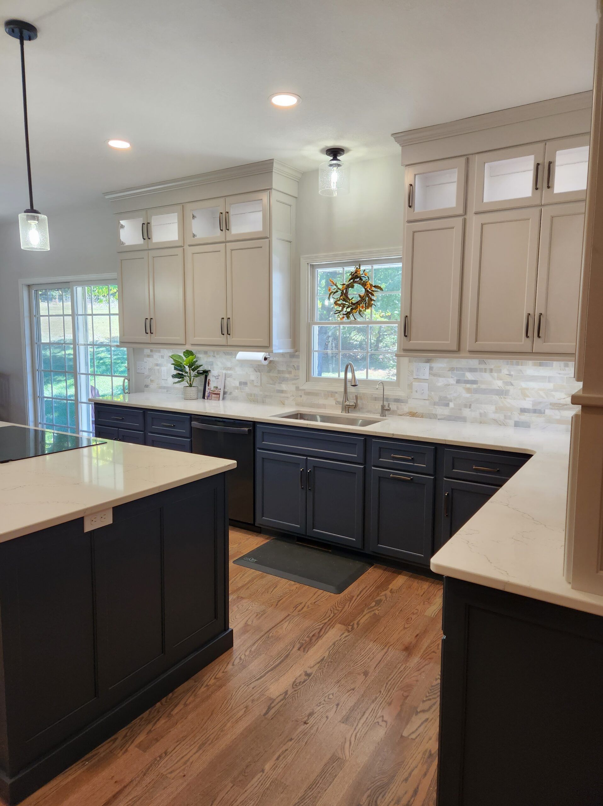 A kitchen with black cabinets and white counter tops