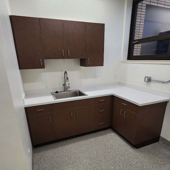 A kitchen with wooden cabinets and a sink
