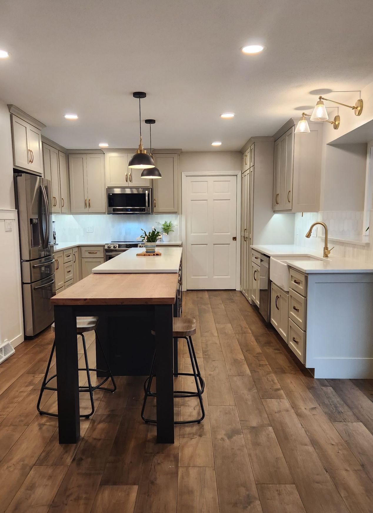 A kitchen with a table and stools in it