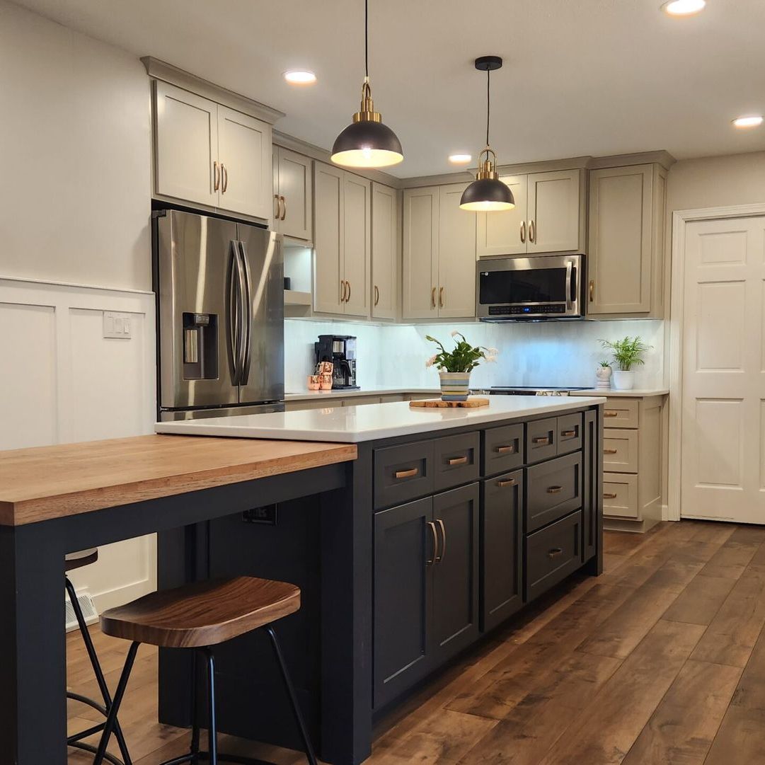 A kitchen with a large island and a wooden table