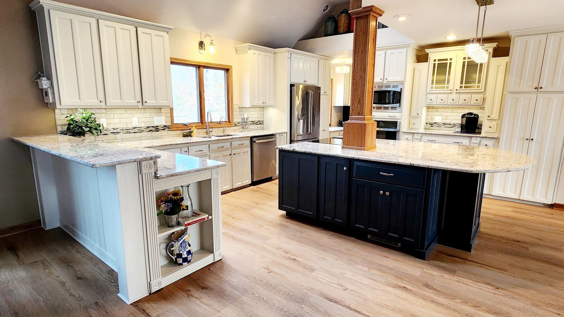 A large kitchen with a large island in the middle of it.
