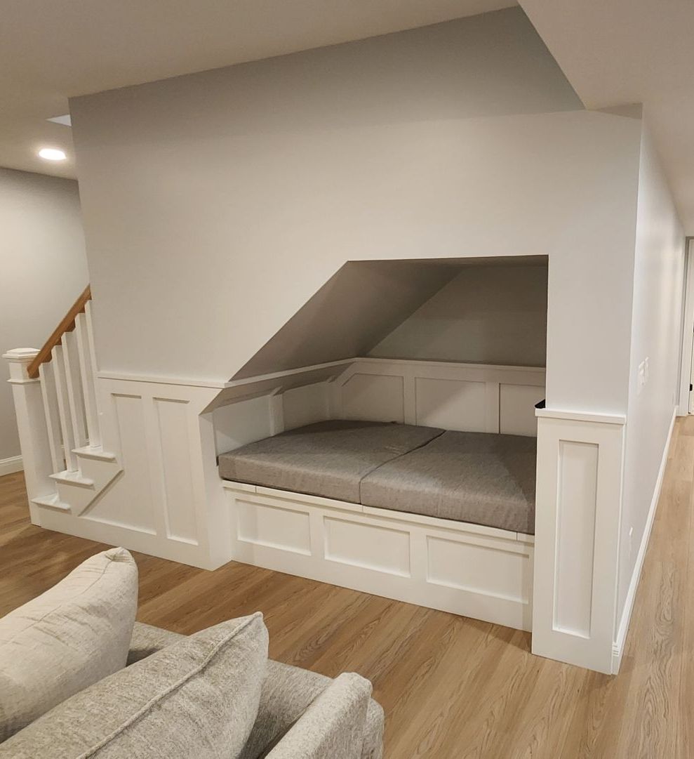 There is a pool table in the middle of a remodeled basement