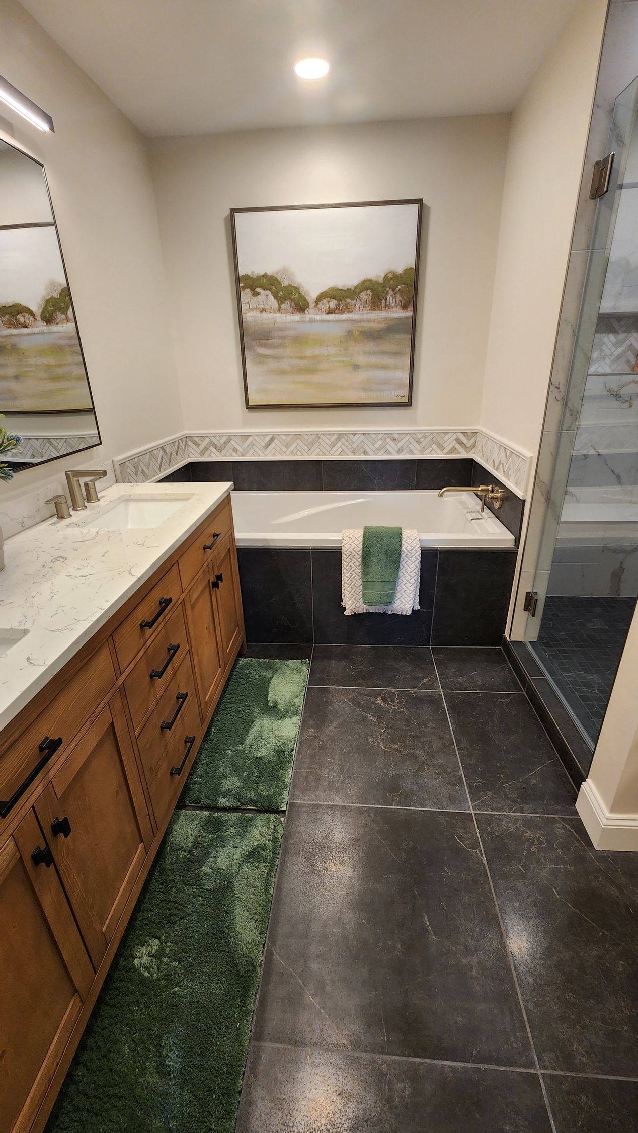 A kitchen with black cabinets and white counter tops