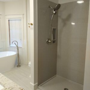 A bathroom with a walk in shower and a bathtub.