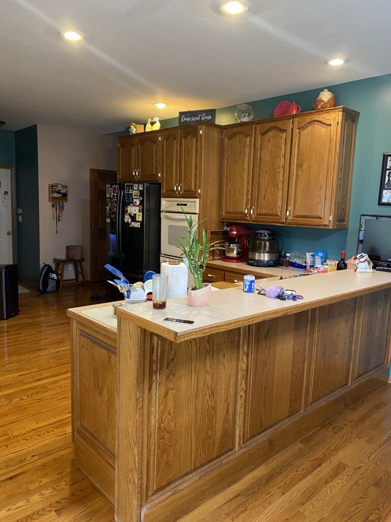 A kitchen with wooden cabinets and a large island.