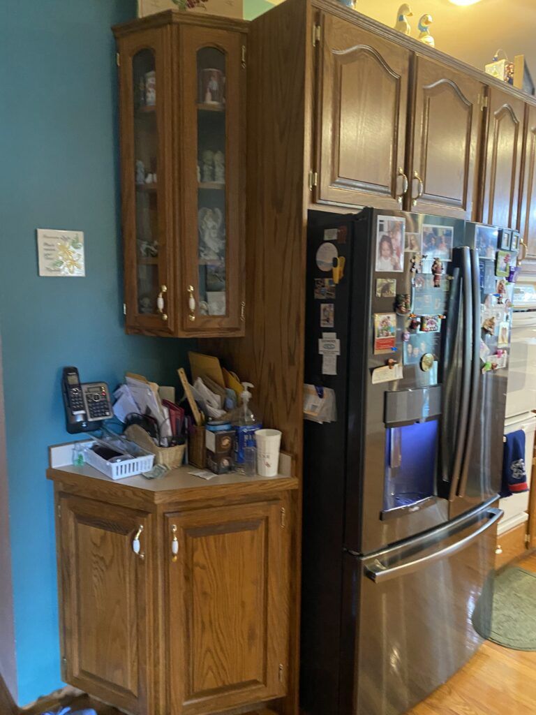 A kitchen with stainless steel appliances and wooden cabinets.