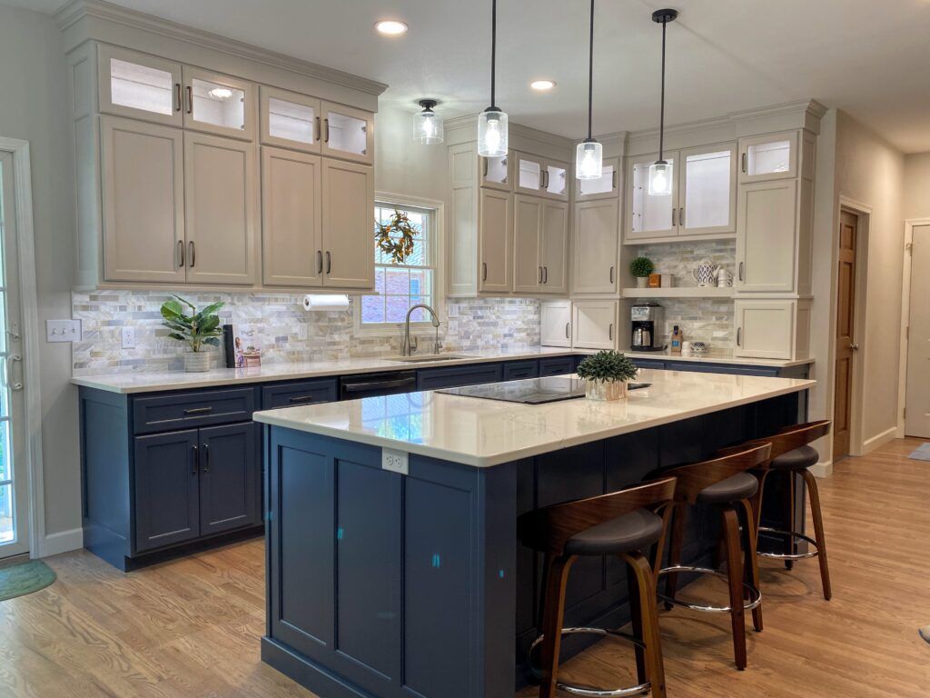 A kitchen with a large island and stools.
