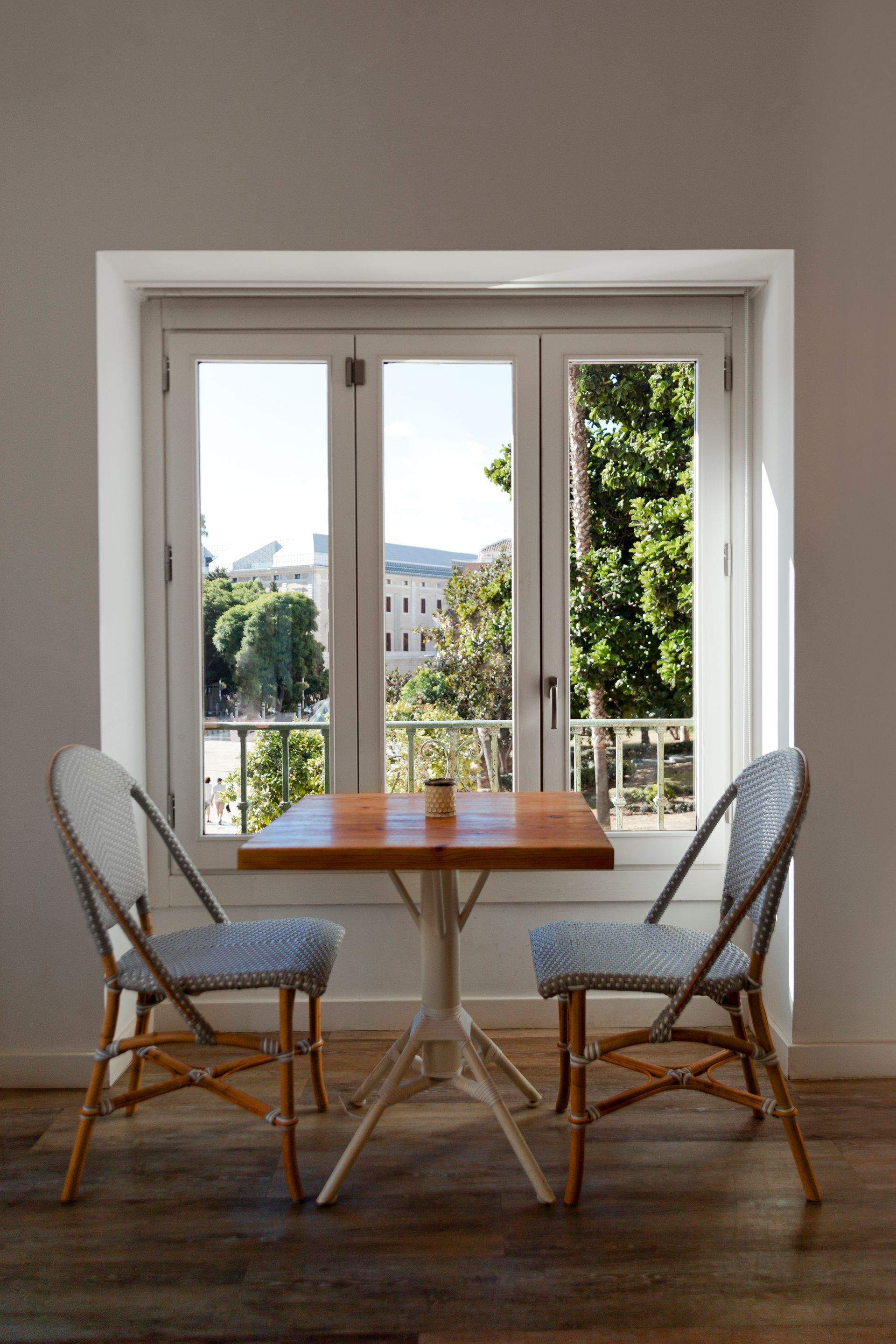 there is a table and chairs in front of a window .