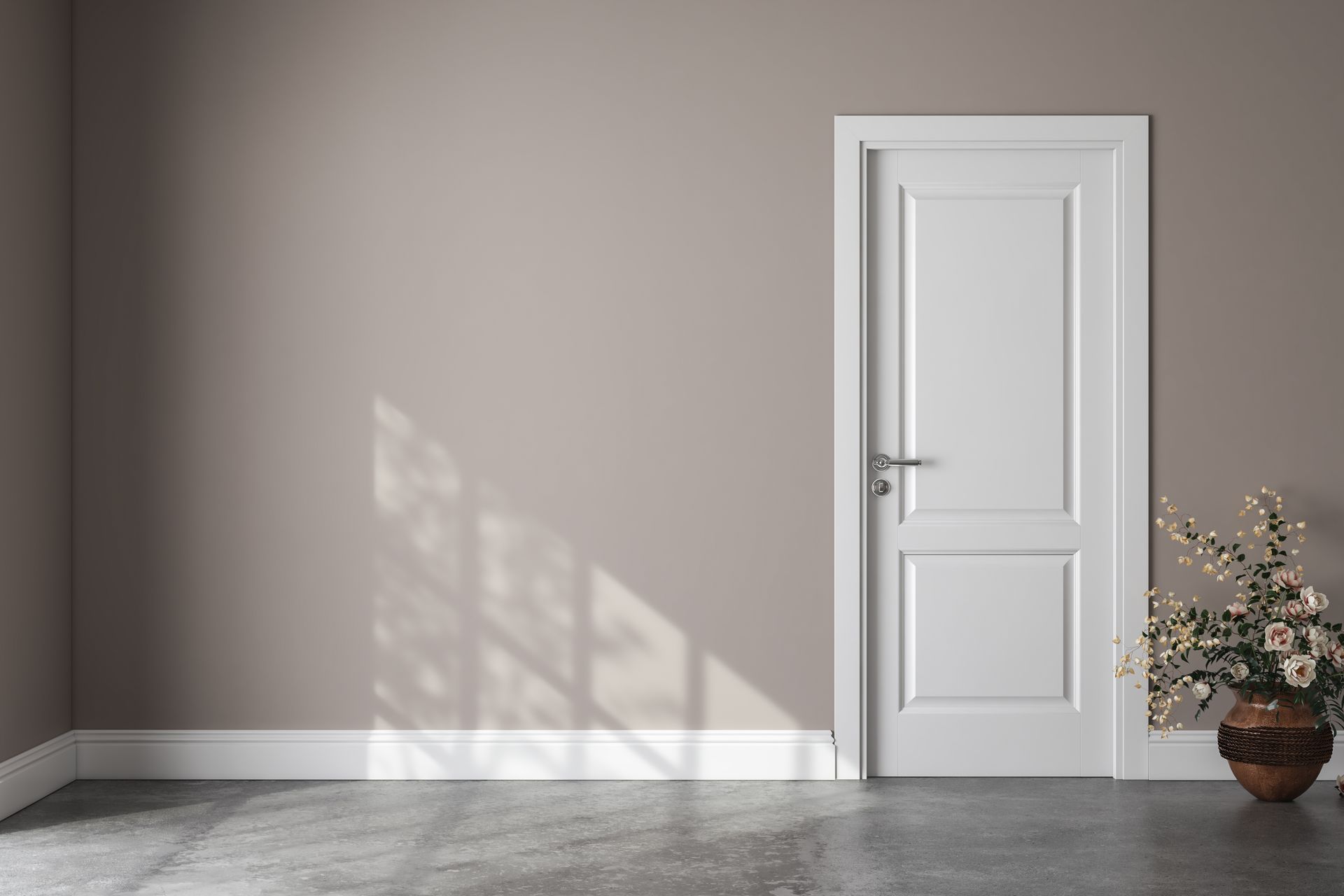 an empty room with a white door and a vase of flowers .
