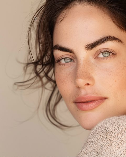 Woman with fair skin, freckles, and blue eyes; looking at the camera. Soft, natural lighting.