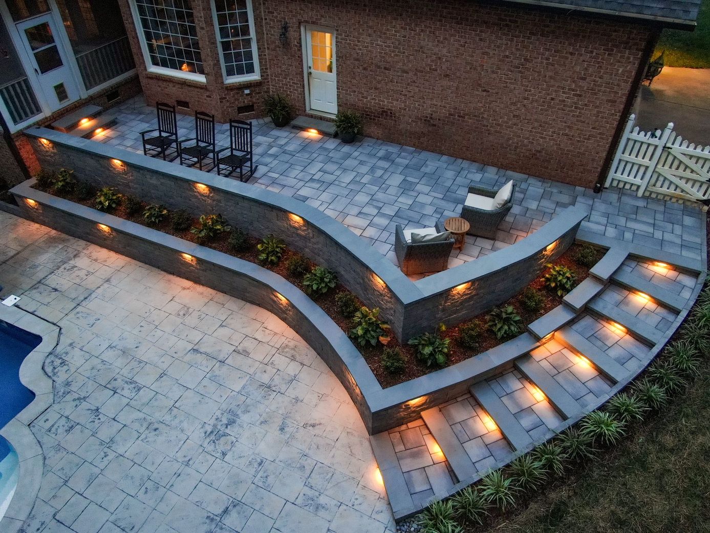 Henry Property Services crew reviewing a patio layout plan at a Central PA backyard